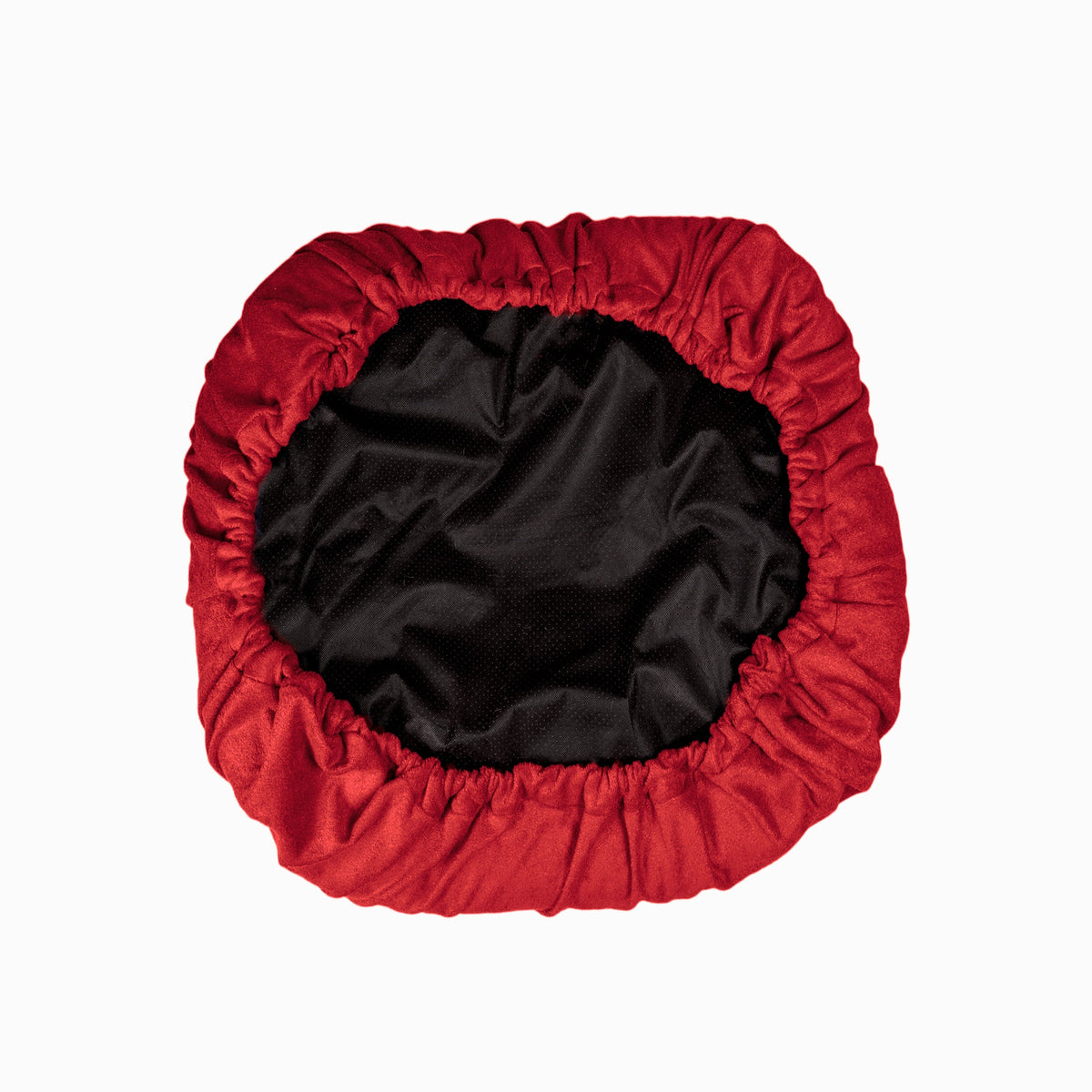 The underside of a red NASH bamboo dog bed cover.