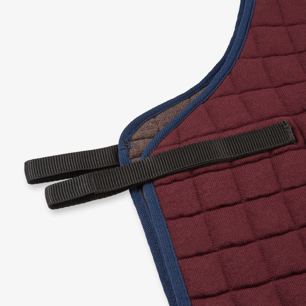 Thermatex Quarter Rug in Claret with navy binding, close-up of saddle attachment
