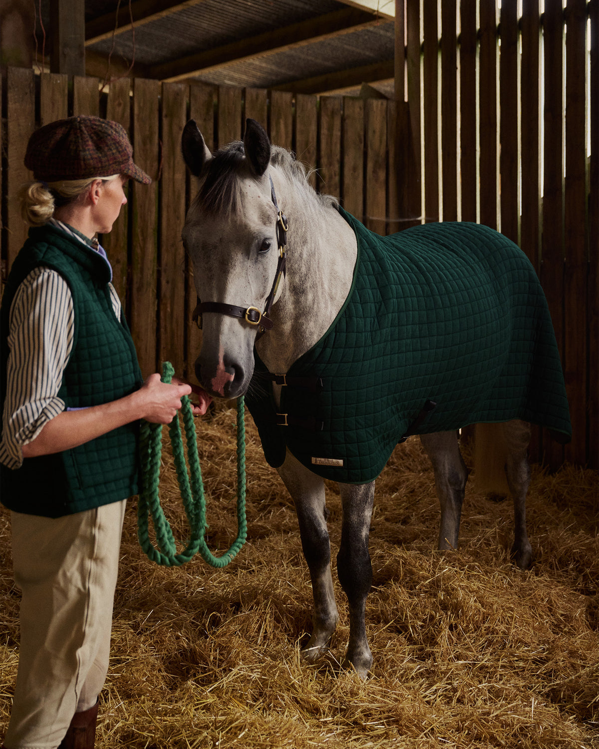 Horse wearing a Thermatex Original Cooler Rug in Bottle Green