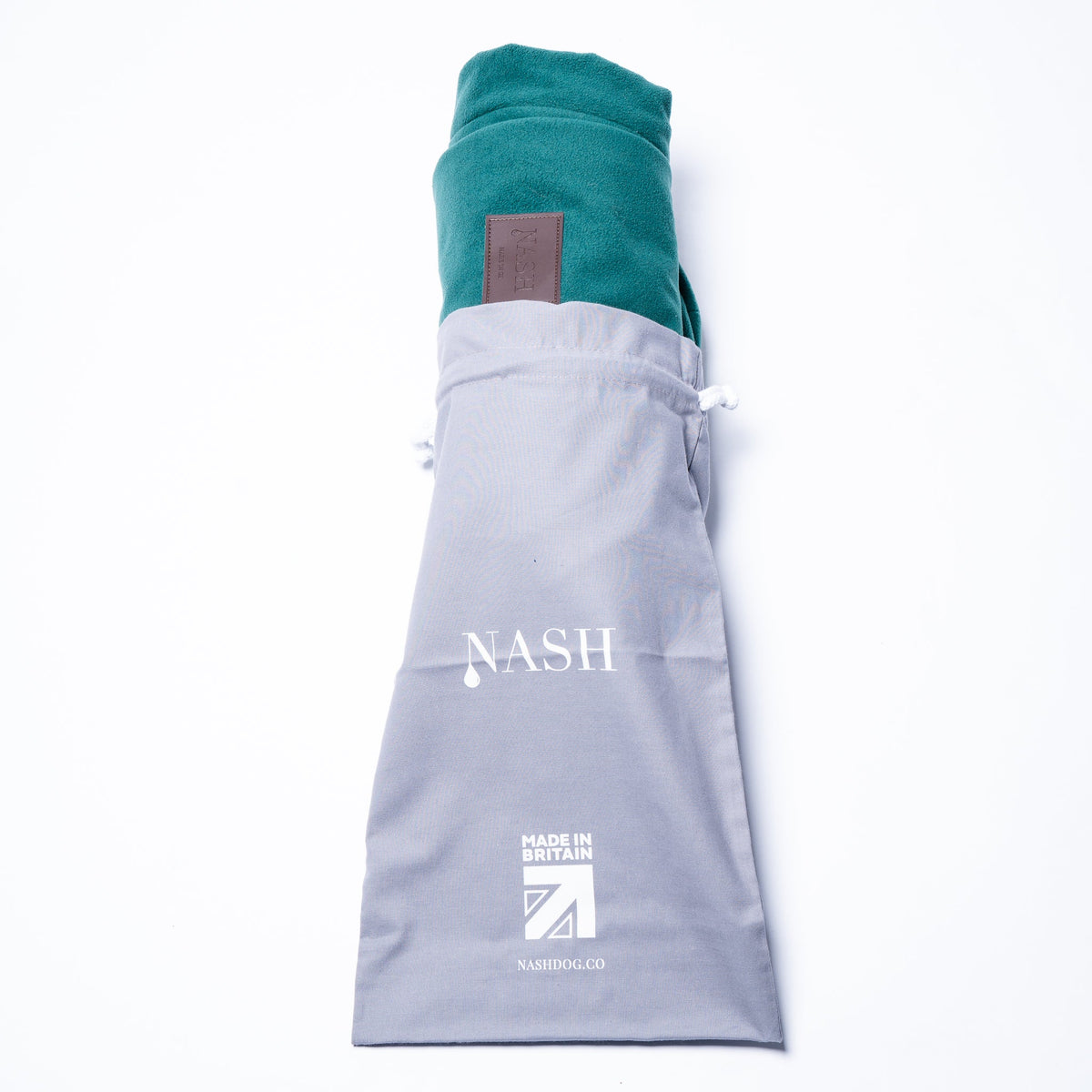 A NASH waterproof microfleece dog bed cover, half placed in its reusable NASH branded bag. 